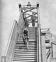 Riding down Madras Street overbridge on a fixed wheel bike, 1900. 